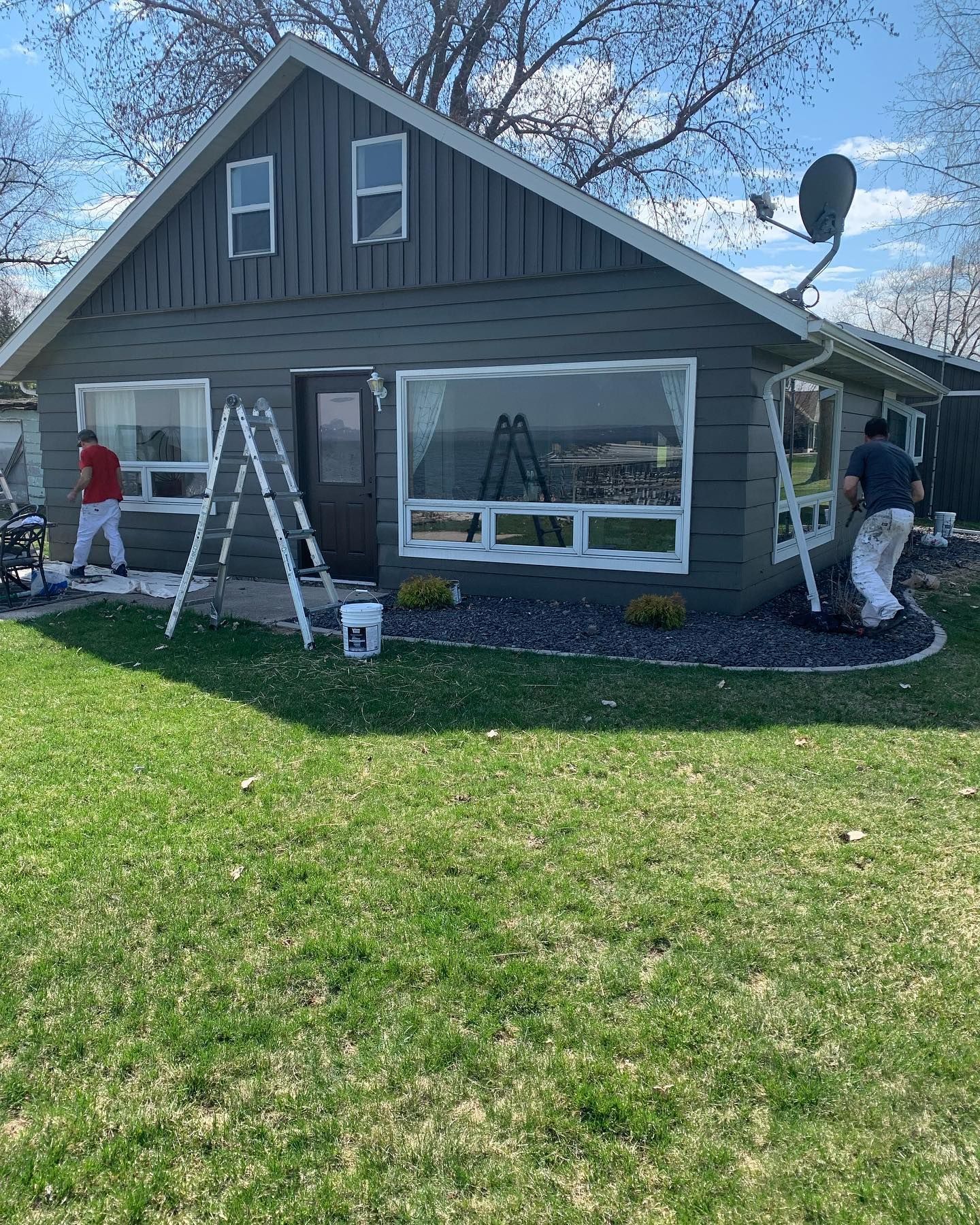 A man is painting the side of a house.