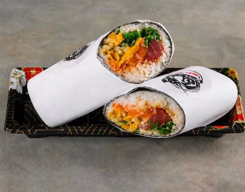 Two wrapped burritos on a tray, one cut open to show rice, vegetables, and meat