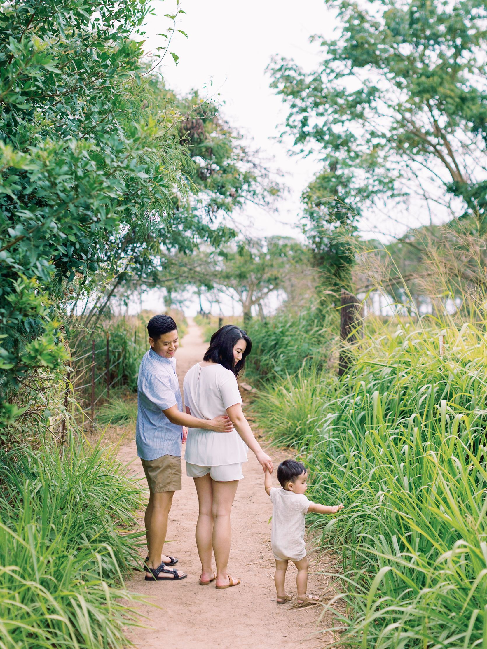 Family walking down a garden path holding hands