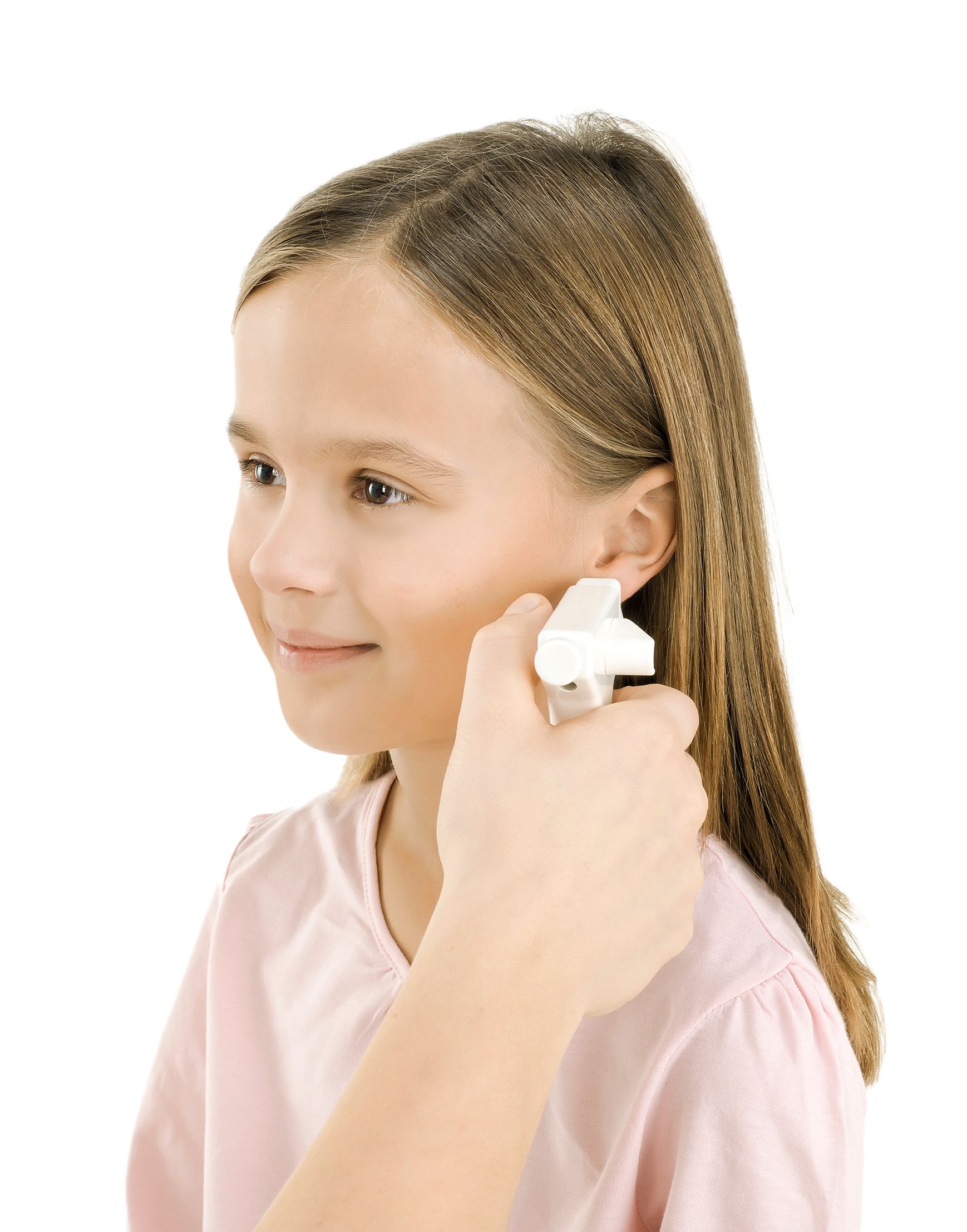 A young girl is getting her ear pierced by a person.