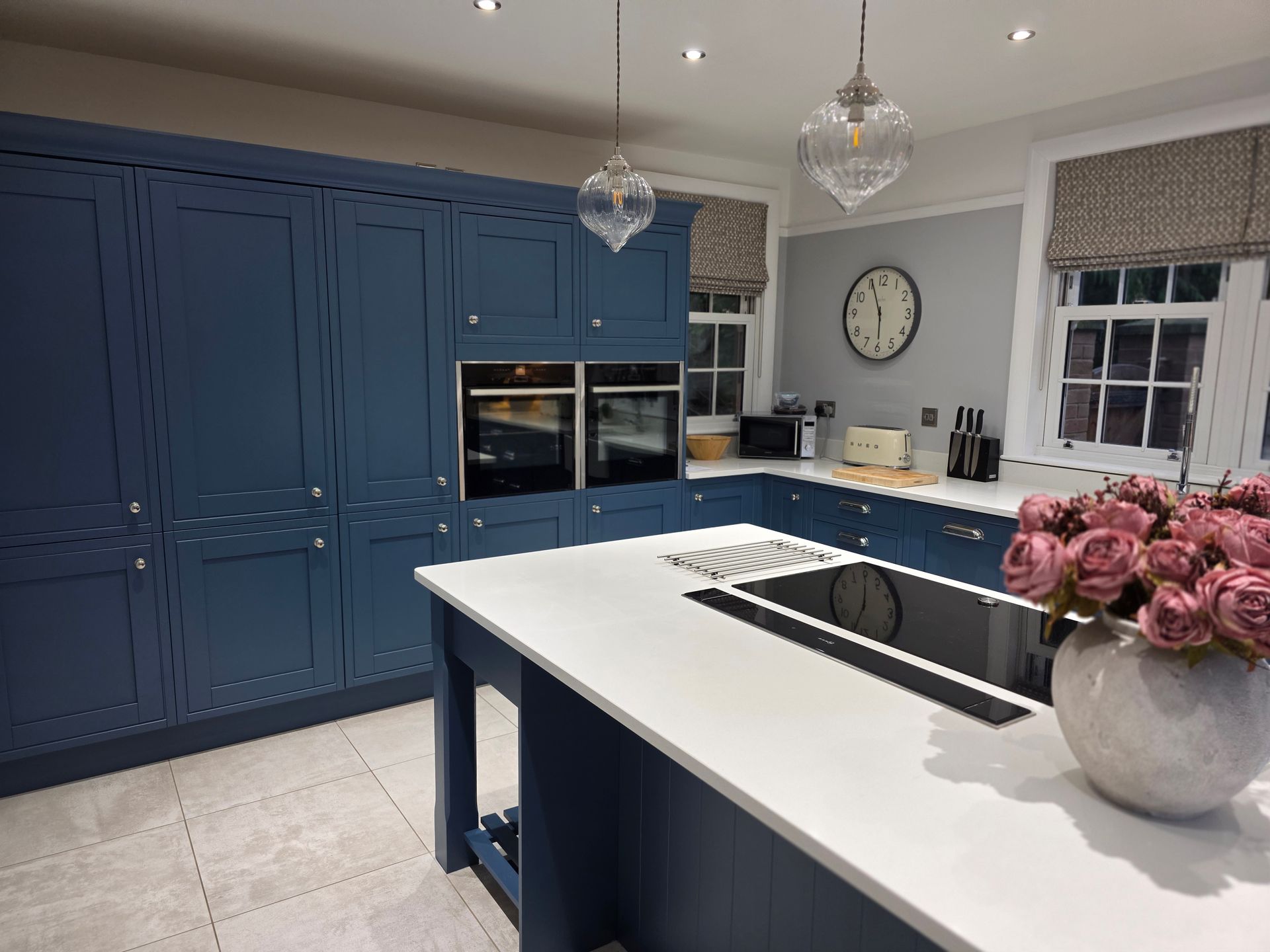 Bespoke kitchen respray with blue cabinets and island