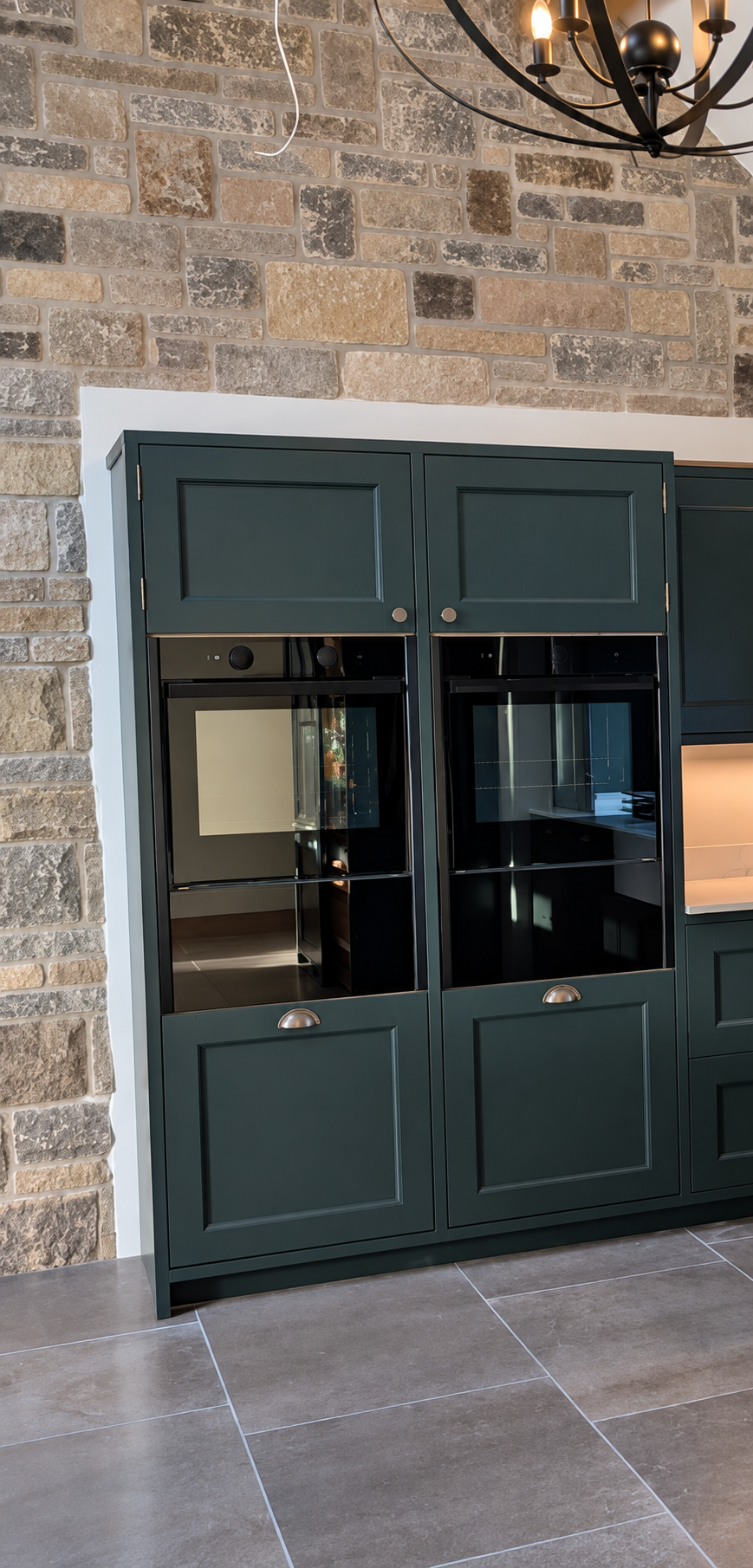 Professionally sprayed kitchen cabinets with a smooth finish around integrated ovens