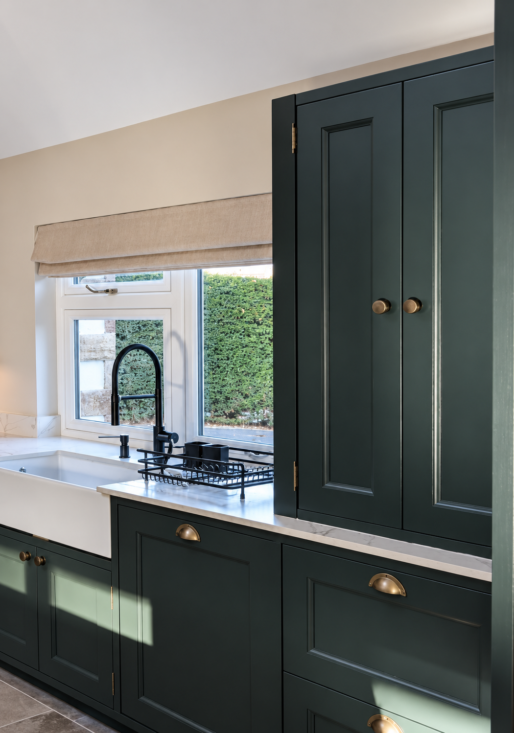 Professionally resprayed kitchen cabinetry with a smooth custom colour finish beside the sink area