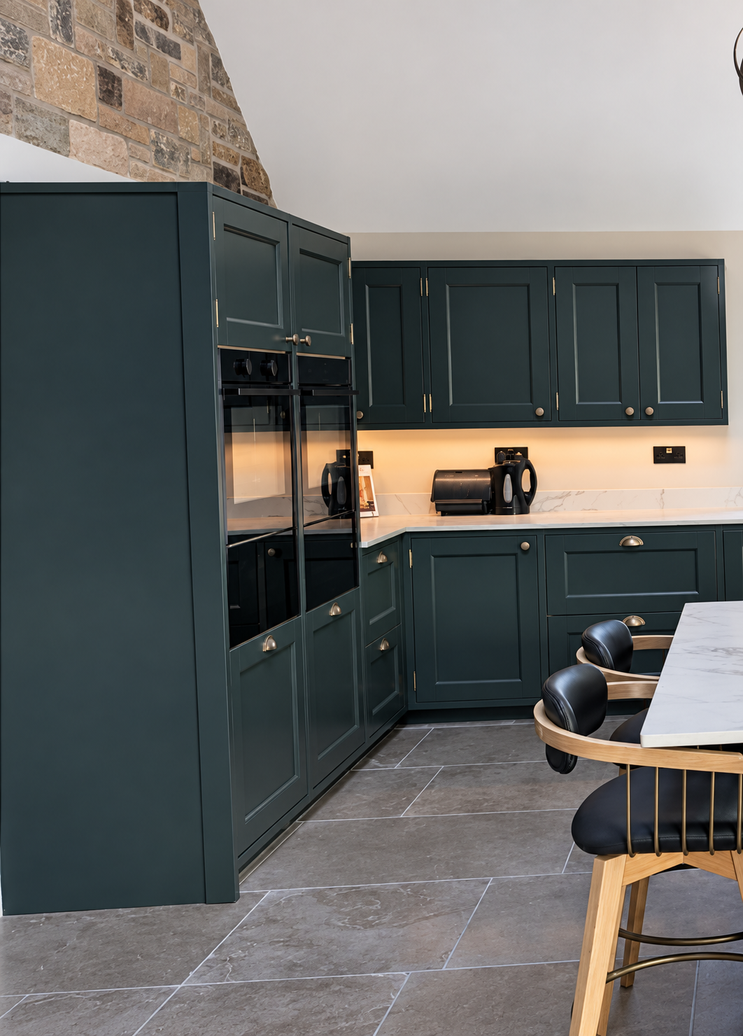 Finished kitchen after professional cabinet spraying with a consistent dark colour across the units