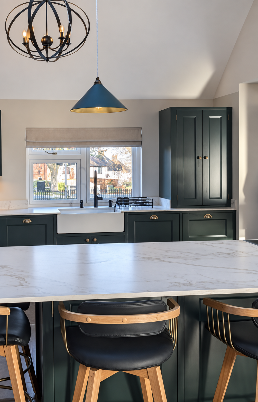 Finished kitchen respray showing consistent sprayed cabinet fronts around the sink and worktop area