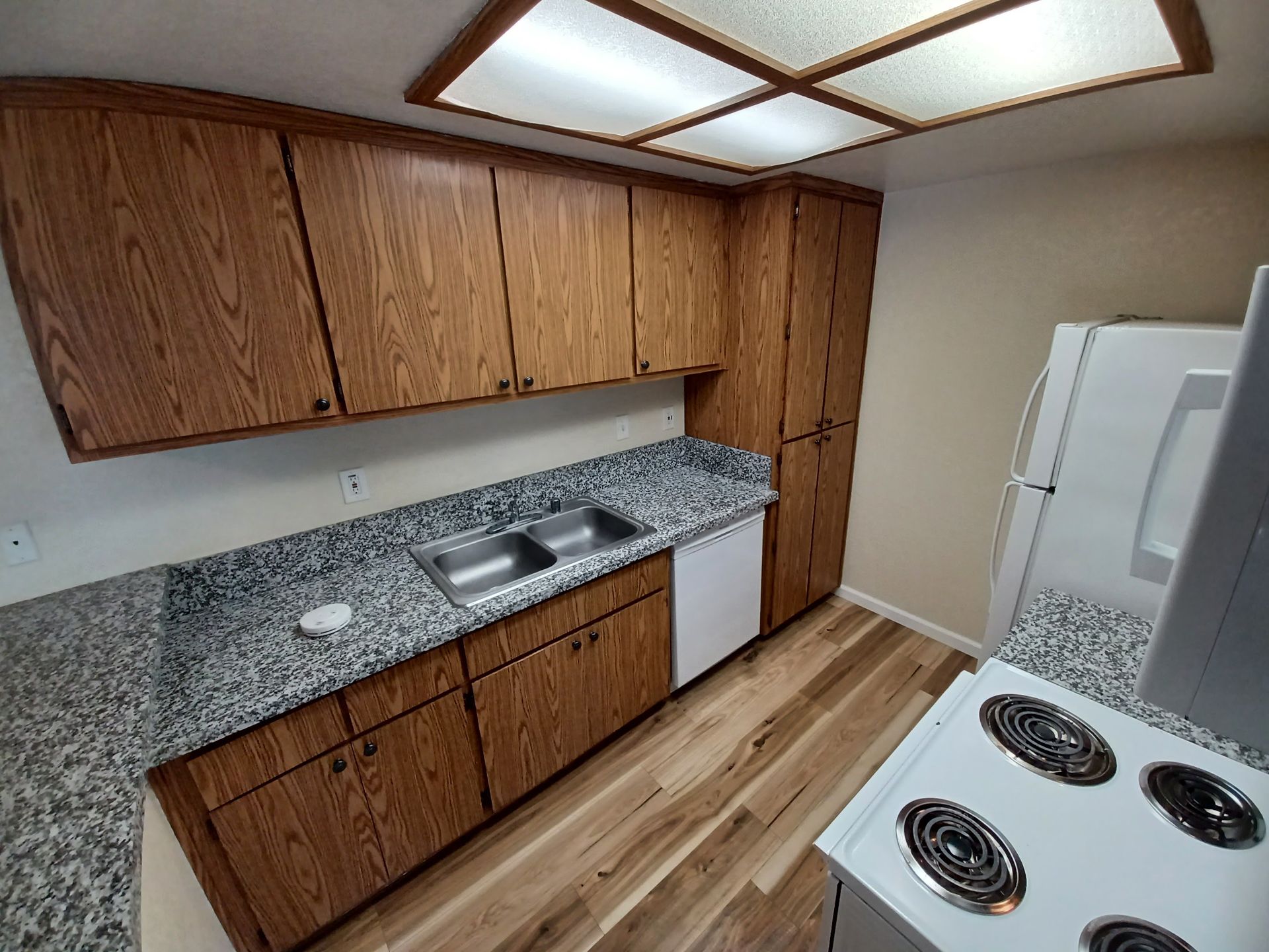 A kitchen with wooden cabinets and granite counter tops