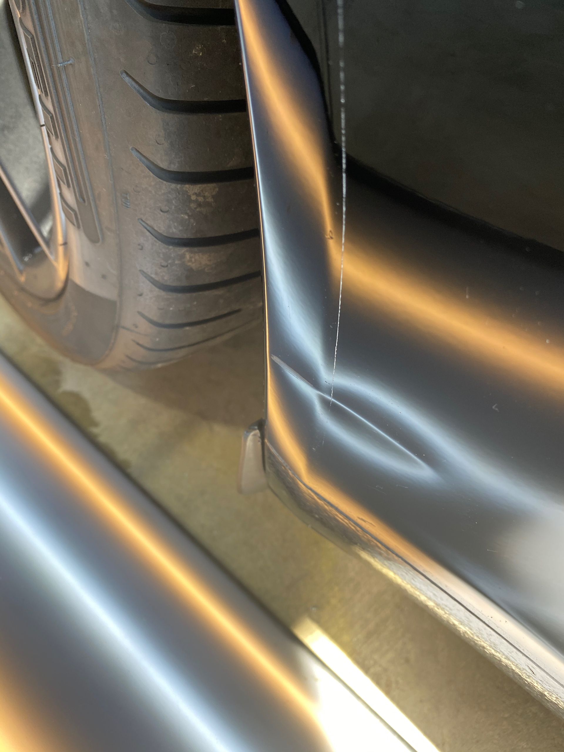A close up of a car with a damaged bumper