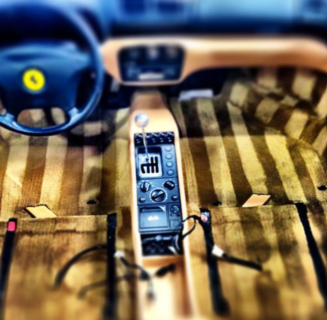 Voicemail recorder on striped wooden surface beside blue headphones and a docked phone
