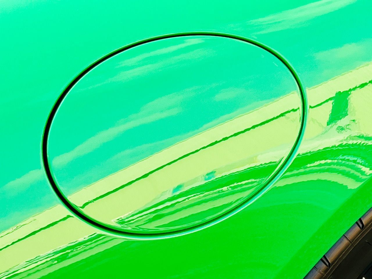 A close up of a green car 's gas cap