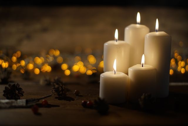 Close-up of burning candles creating a calm and reflective atmosphere for a memorial service.