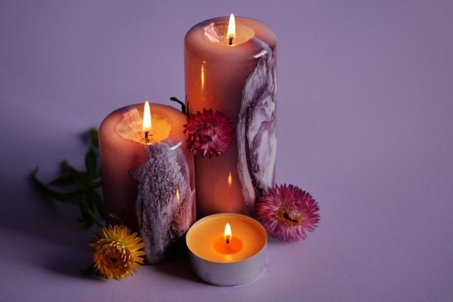 Warm candlelight with flowers arranged for a peaceful funeral tribute.