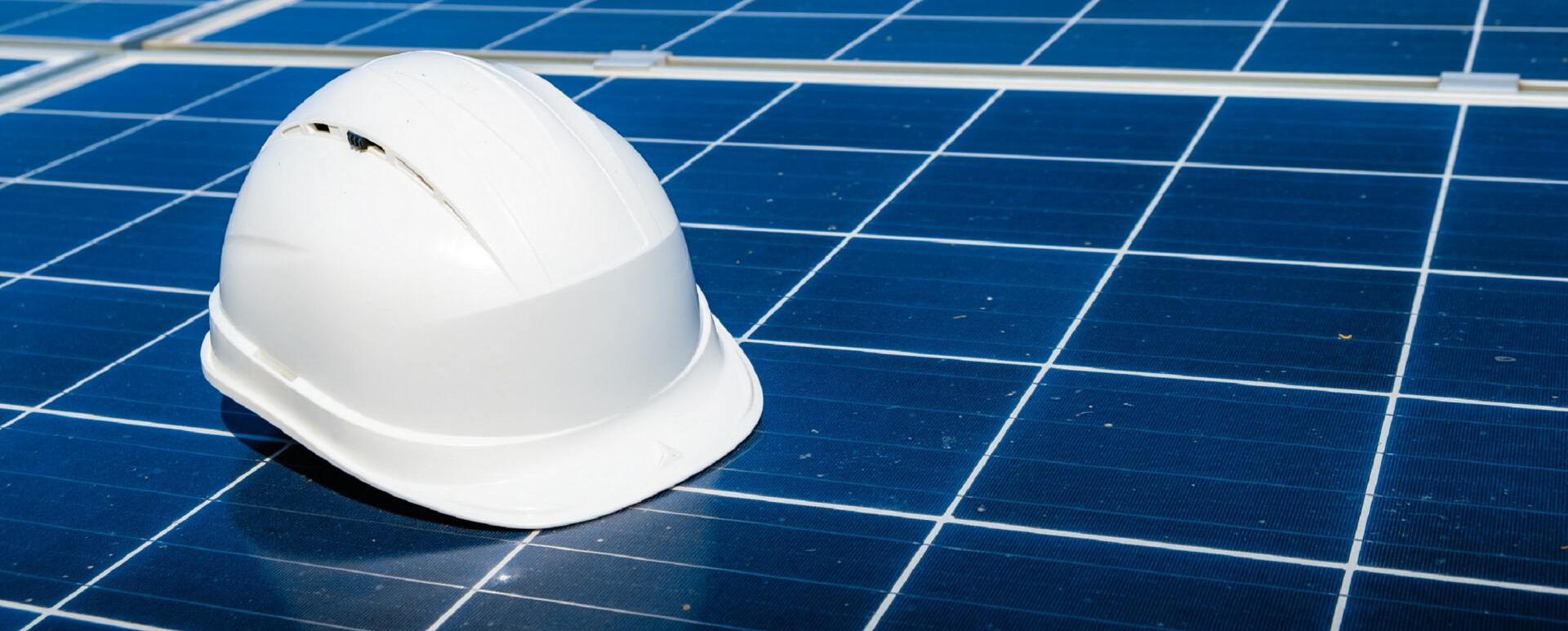 hard hat on solar panels