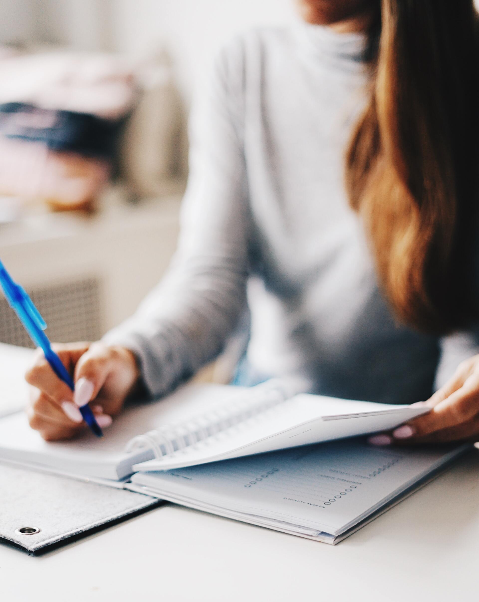 woman writing in calendar