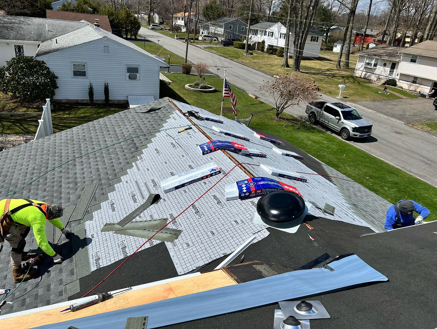 A house is being remodeled with a roof being installed.