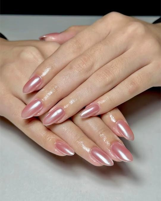 Manicured hands with glossy pink ombré almond-shaped nails