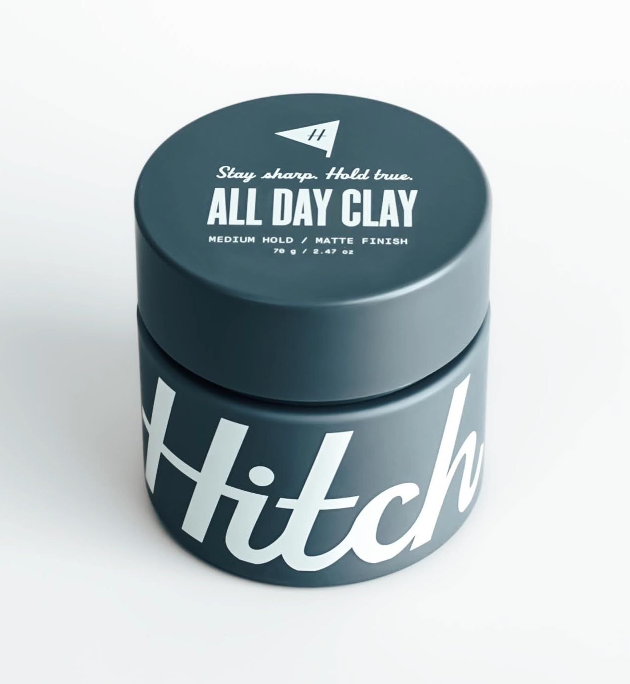 A jar of hitch all day clay on a white background