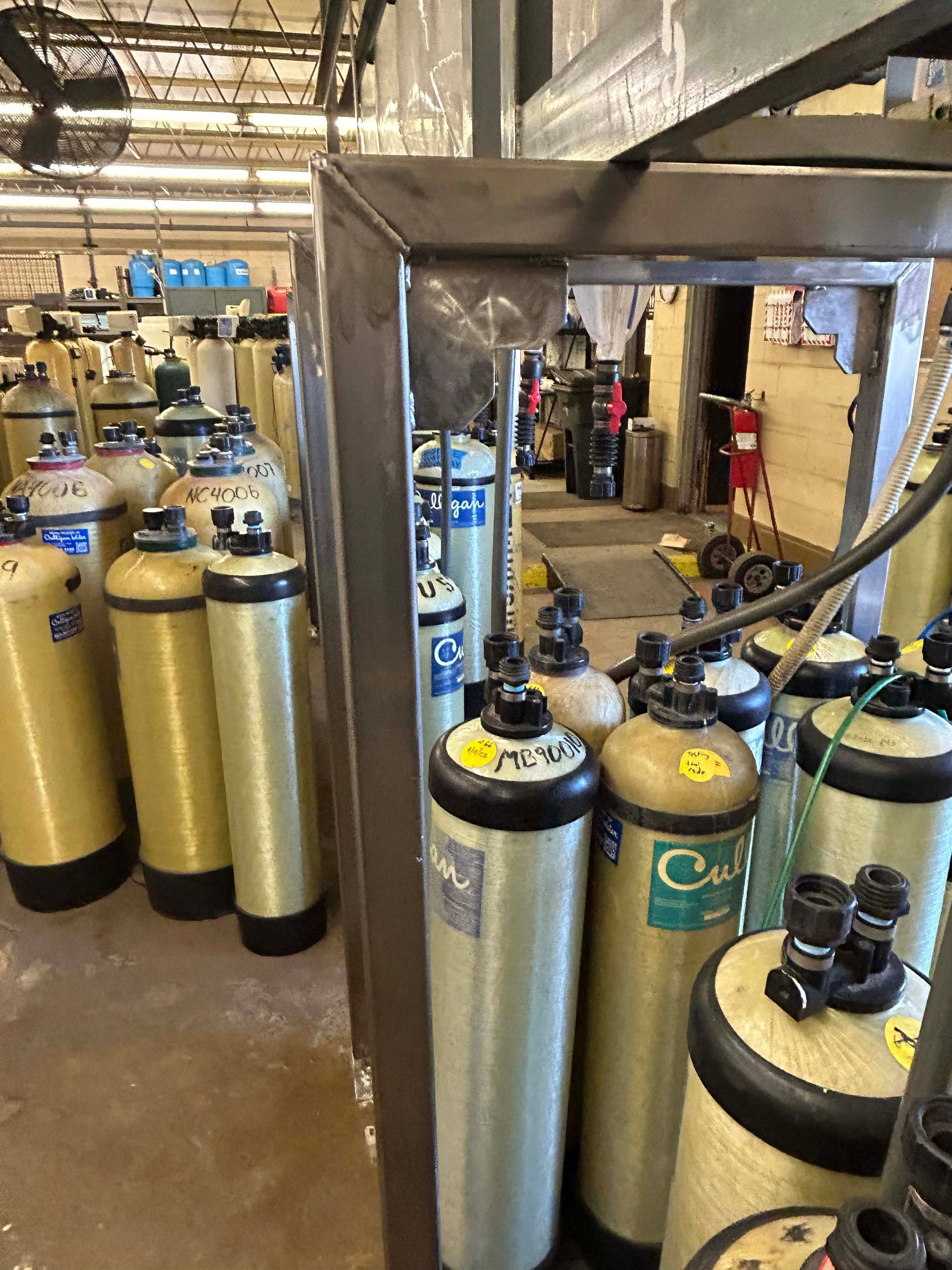 Rows of cylindrical water filtration tanks in an industrial setting.