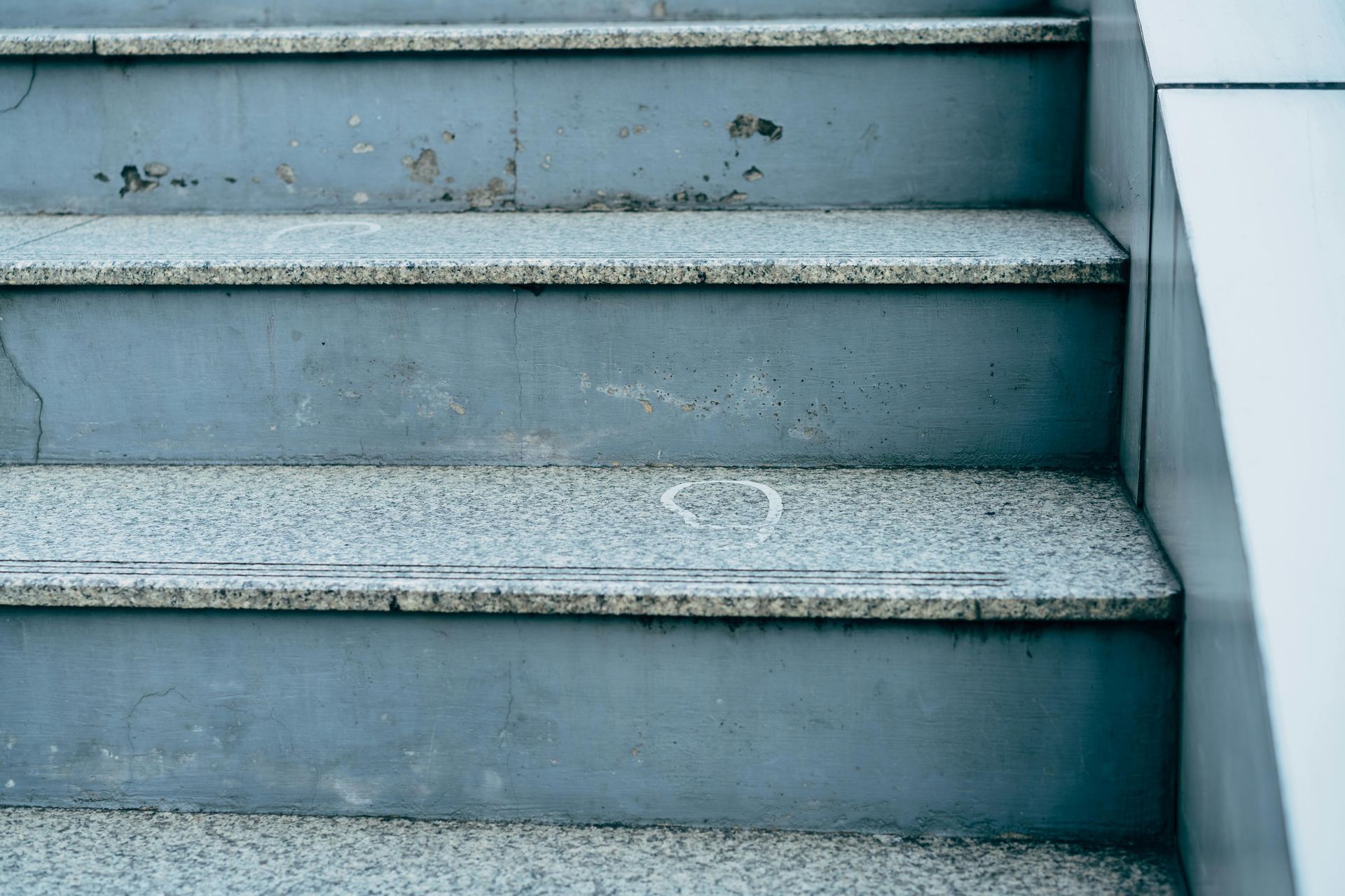 Gray concrete stairs with speckled granite steps.