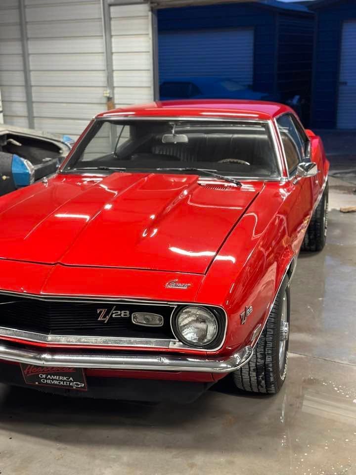Red classic muscle car displayed indoors with glossy paint and chrome trim. | Pro Veterans Automotive