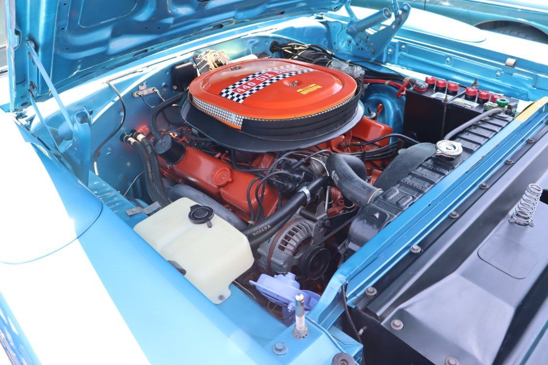 Classic car engine bay with bright red engine and blue body panels | Pro Veterans Automotive