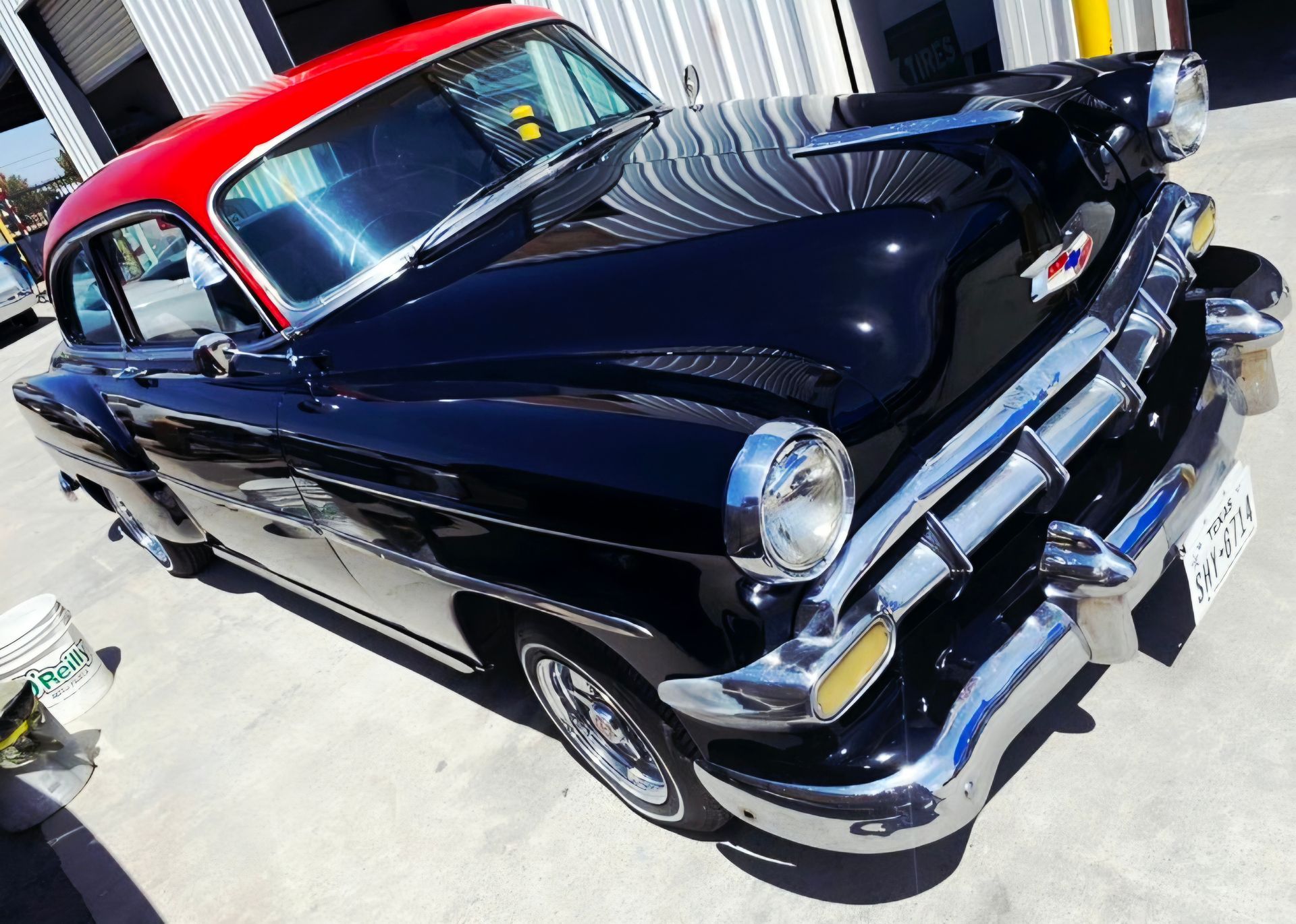 Classic black vintage car with red roof parked outdoors in sunlight | Pro Veterans Automotive