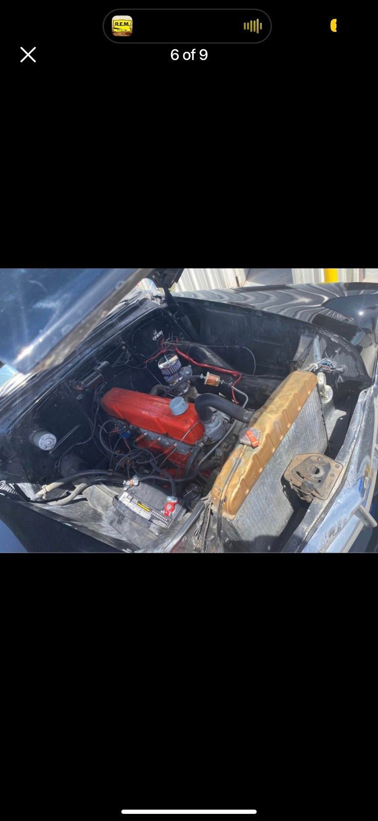 Red engine inside a damaged car, viewed from above with debris and broken metal around it | Pro Veterans Automotive