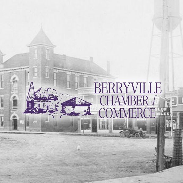 Historical black-and-white view of a town square featuring a brick building and water tower, with Berryville Chamber logo.