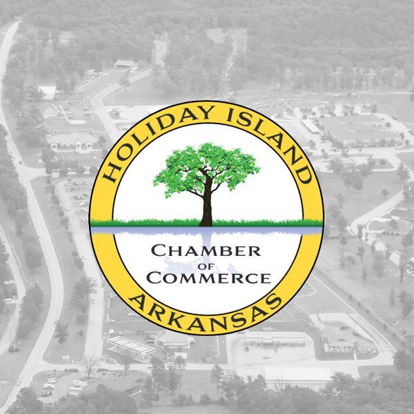 Logo for the Holiday Island Chamber of Commerce in Arkansas, featuring a tree over water inside a circular yellow frame.