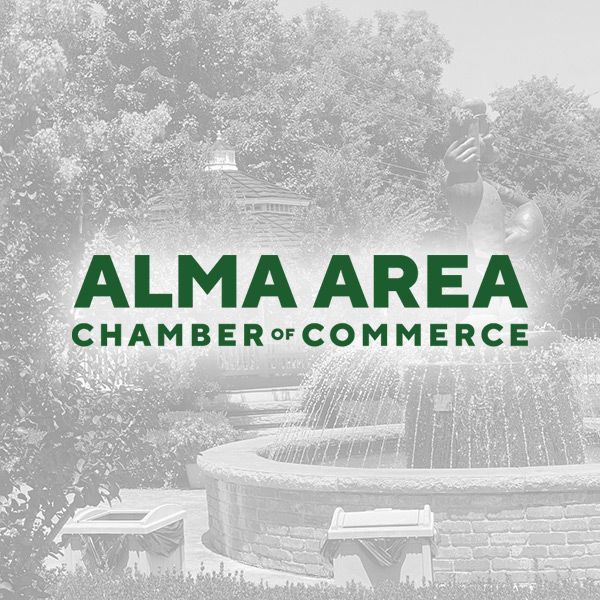 The Alma Area Chamber of Commerce logo in dark green text over a faded photo of a park fountain and gazebo.