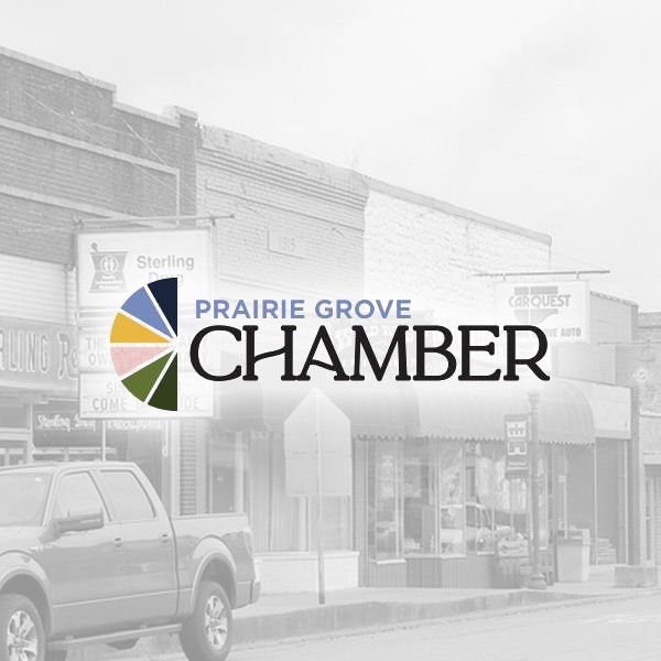 Logo for the Prairie Grove Chamber of Commerce over a faded, black and white street scene.
