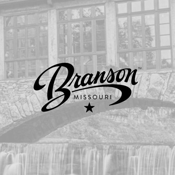 The Branson, Missouri logo overlaid on a grayscale image of a stone bridge and waterfall.