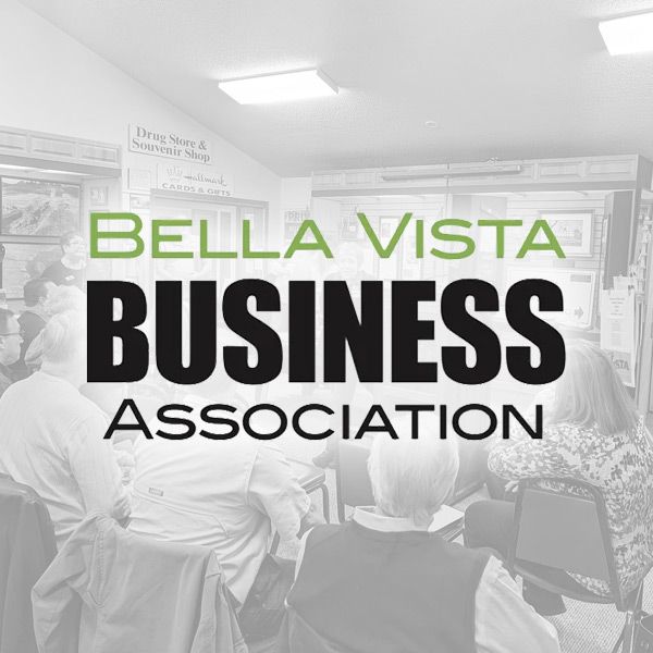 The Bella Vista Business Association logo overlaid on a grayscale photo of people attending a meeting.