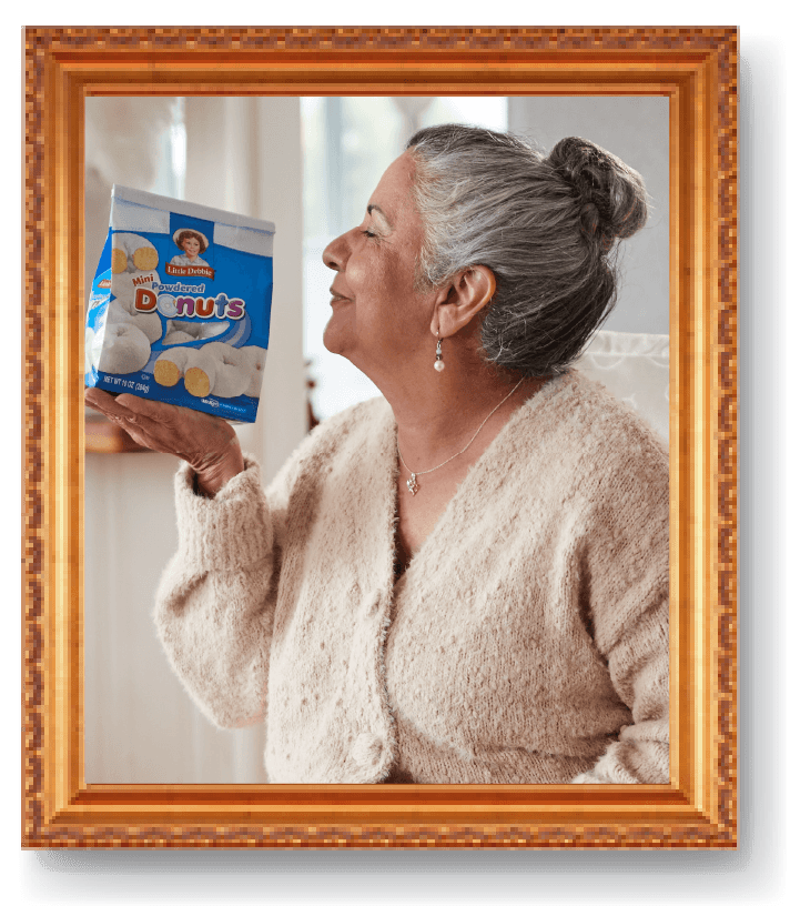 portrait of abuela with a bag of powdered mini donuts