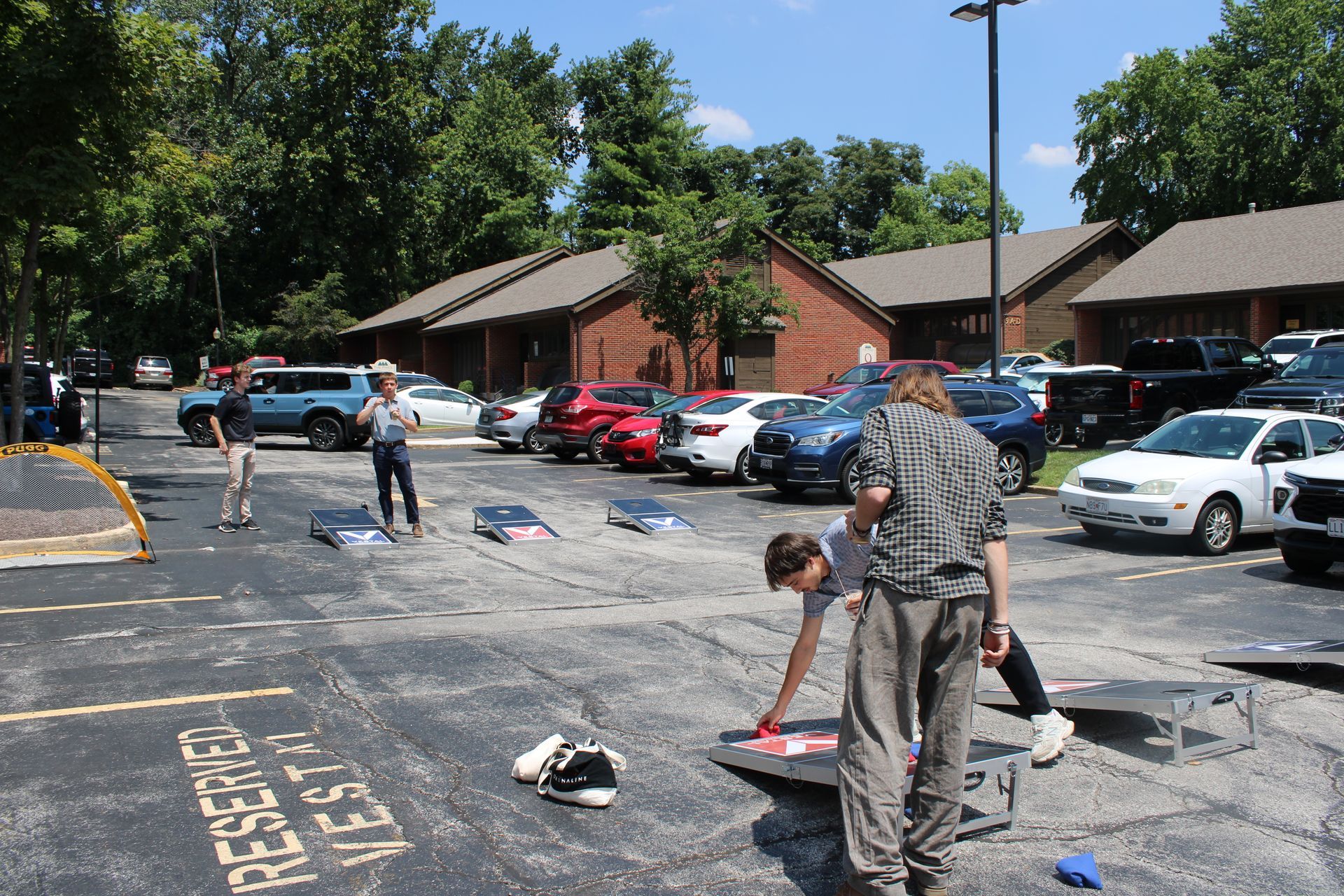 Active community members in a parking lot playing games together. 