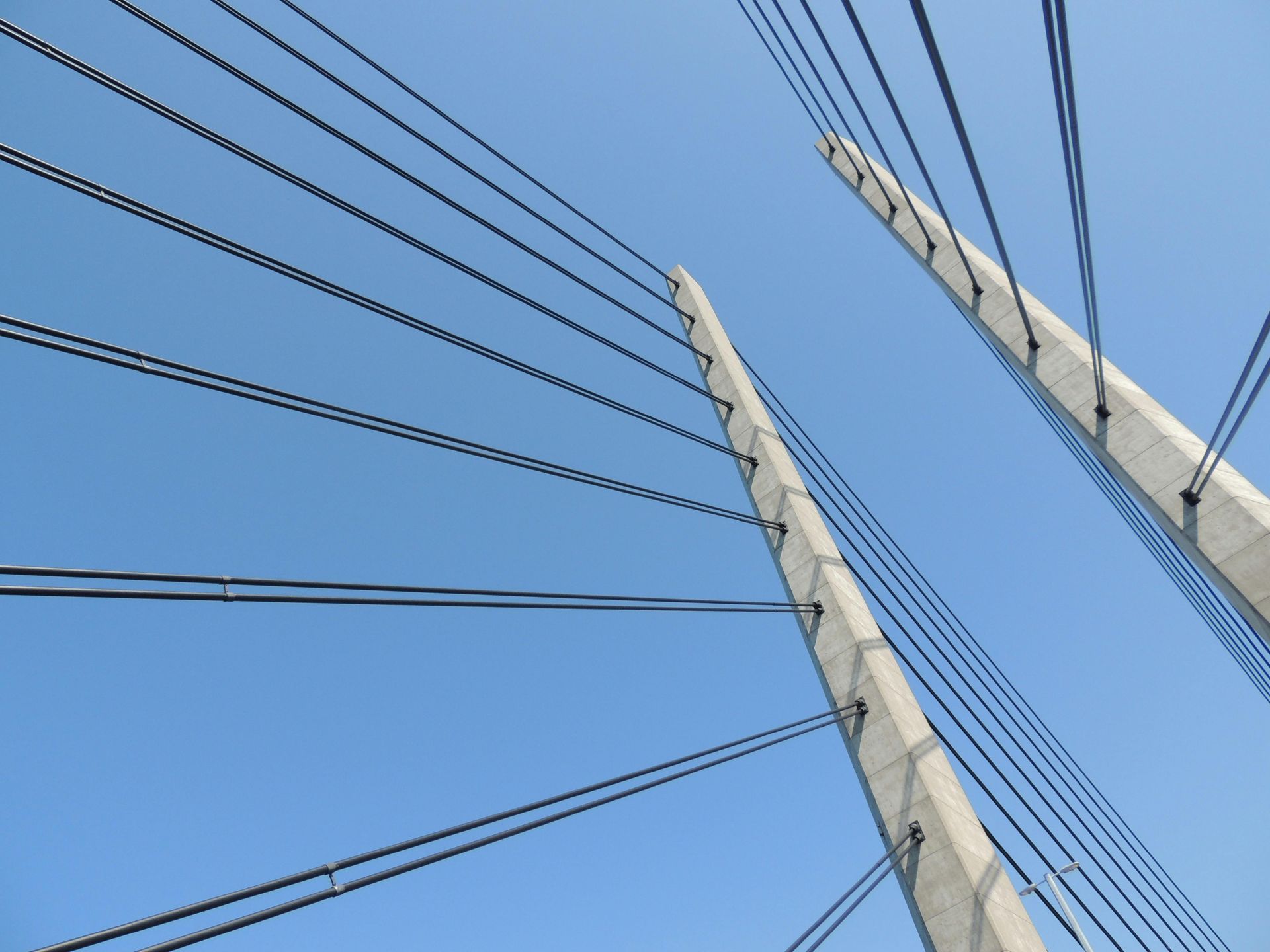Cable-stayed bridge cables against a blue sky