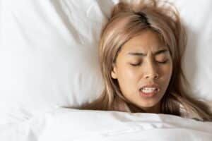 Woman grinds her teeth (bruxism) in Denver