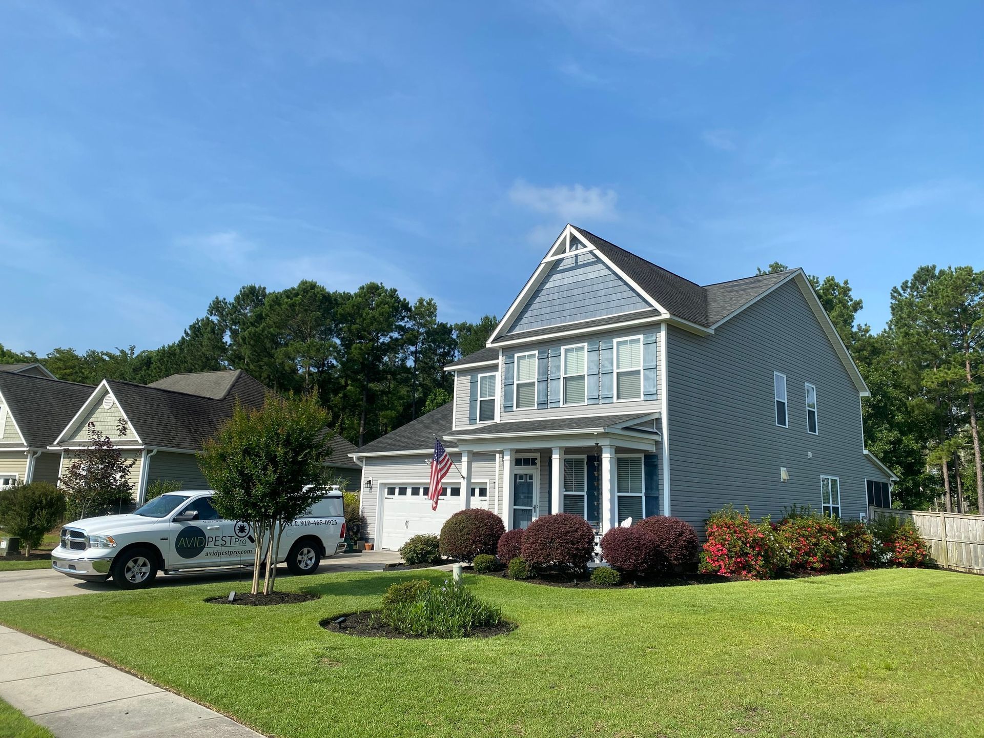 A large house with a white truck parked in front of it.
