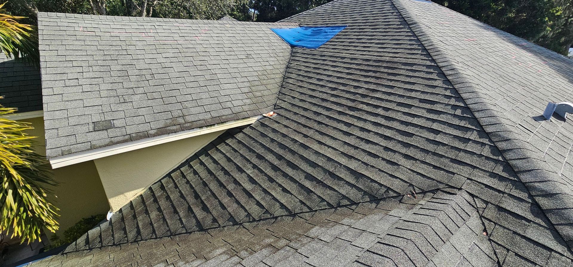 Tile roofing contractor near you: Red Truck Roofing work truck with Florida roofing license CCC1332514 and 813-RED-TRCK on the door in front of a new tile roof