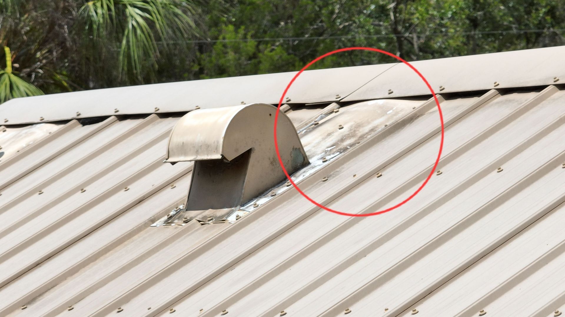 Emergency roof tarping near you: Red Truck Roofing crew fastening a tarp with furring strips over a hurricane opened roof at night in Tampa Bay