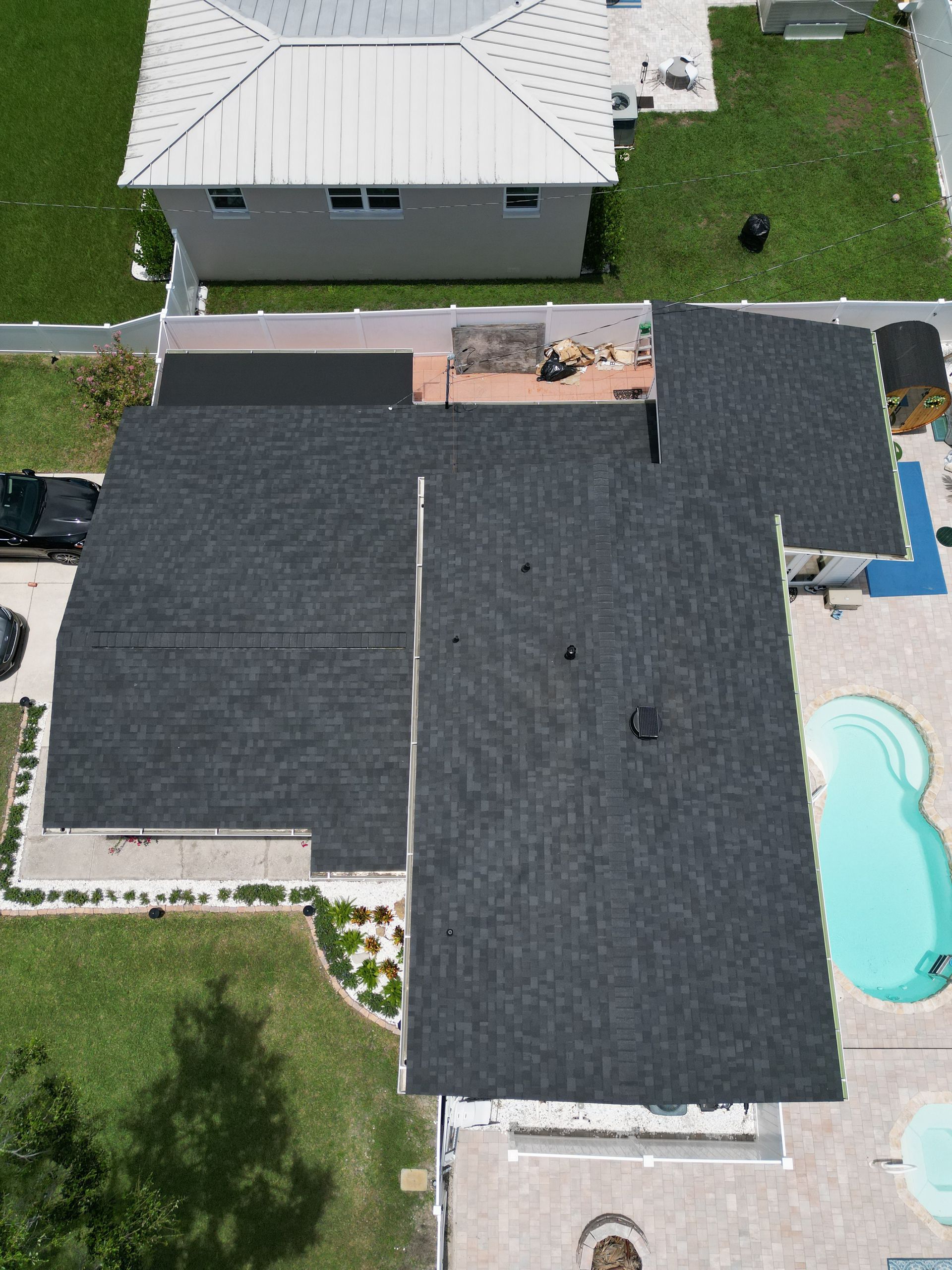 Flat roof installation near you: Red Truck Roofing setting tapered polyiso insulation for positive drainage on a commercial roof deck