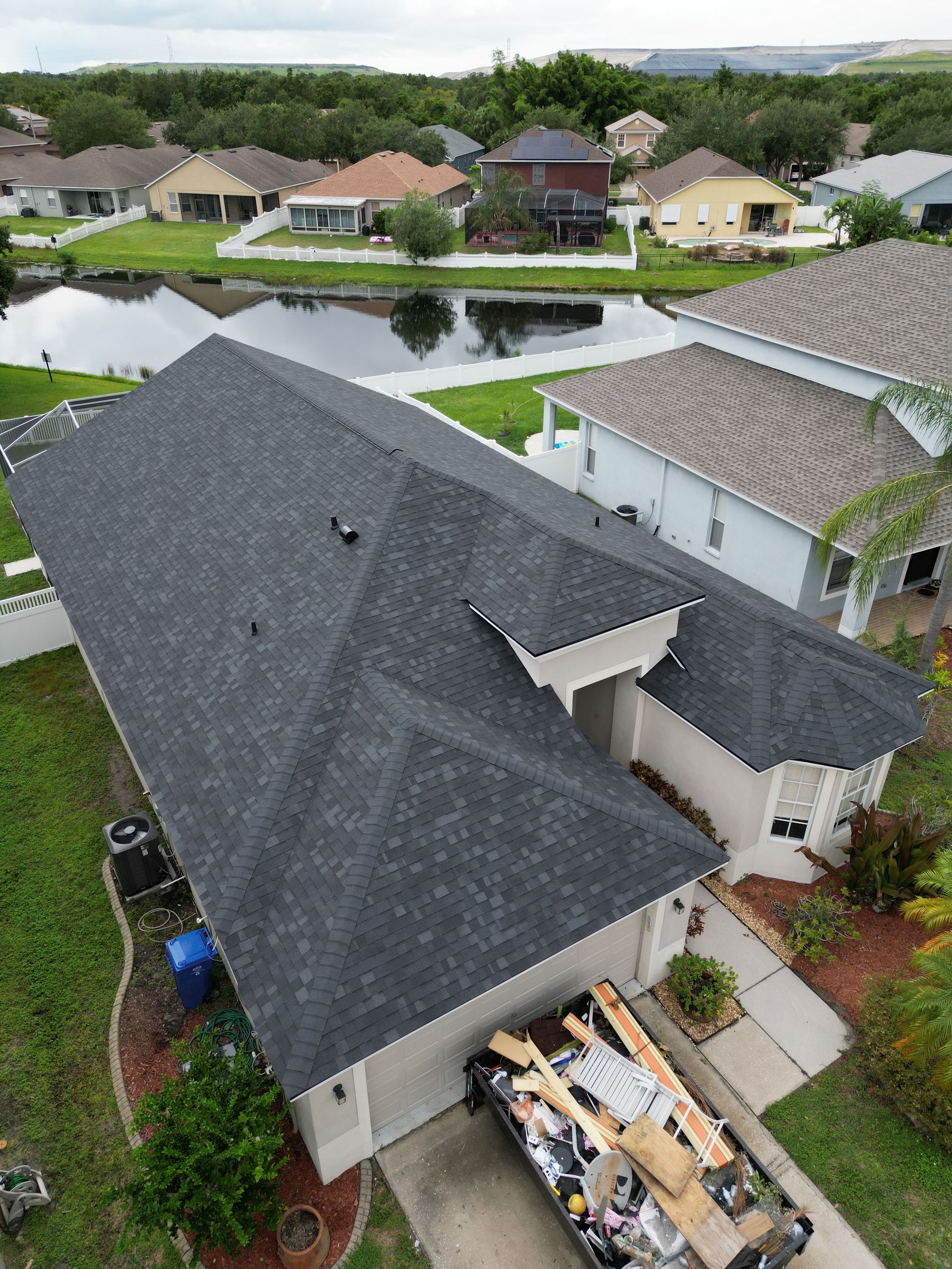 Roofing company Odessa FL line item roof replacement estimate from Red Truck Roofing showing materials, labor, permit fees and decking allowance