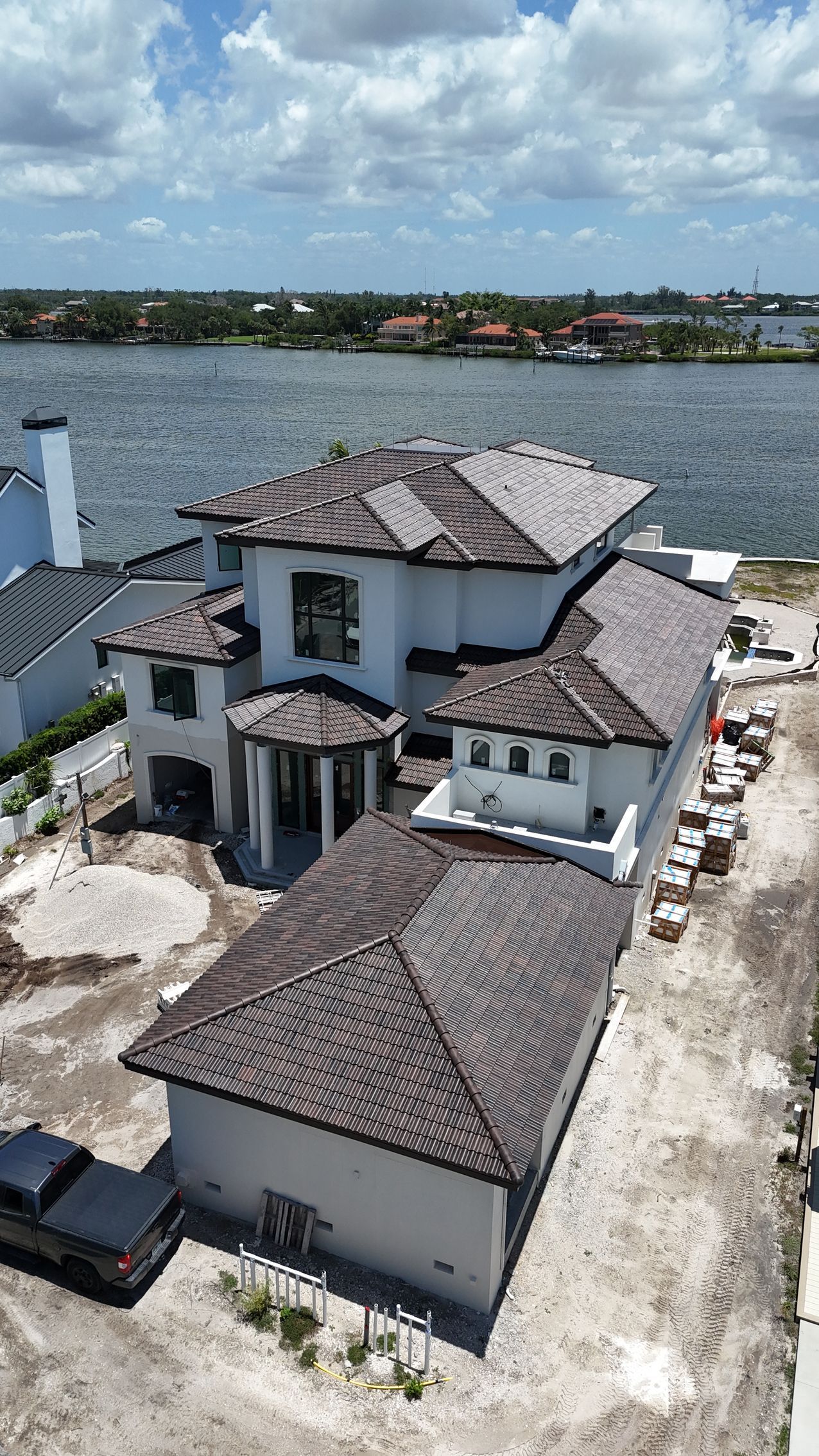 Concrete tile roofing near you: Red Truck Roofing installers laying flat profile Eagle concrete tile on a Tampa Bay home