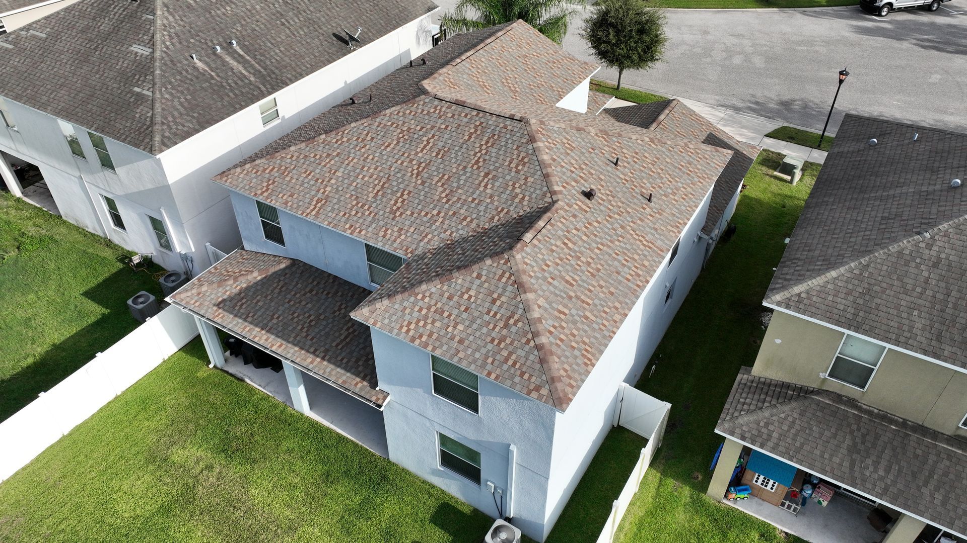 Multi family roofing contractor near you: Red Truck Roofing crews reroofing several apartment buildings at once in a Tampa Bay community