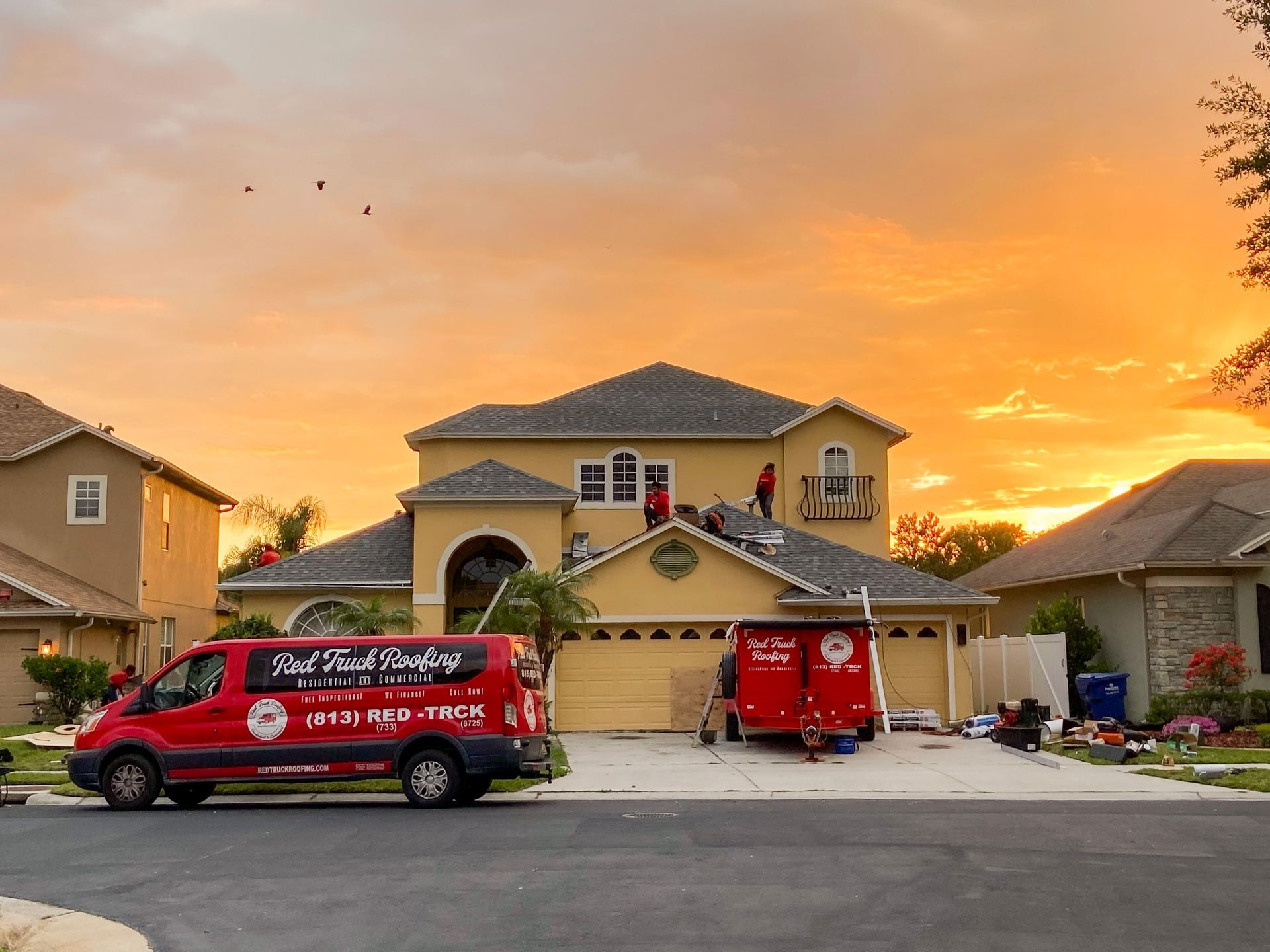 Roofer in Seminole FL inspecting roof decking board by board during a Red Truck Roofing tear off