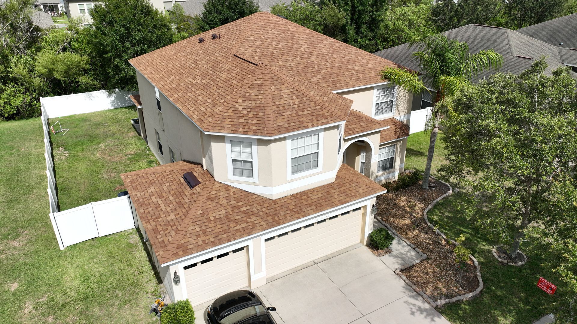 Roof replacement near you: Red Truck Roofing project manager reviewing a county roof permit and final inspection card on a Tampa Bay job site