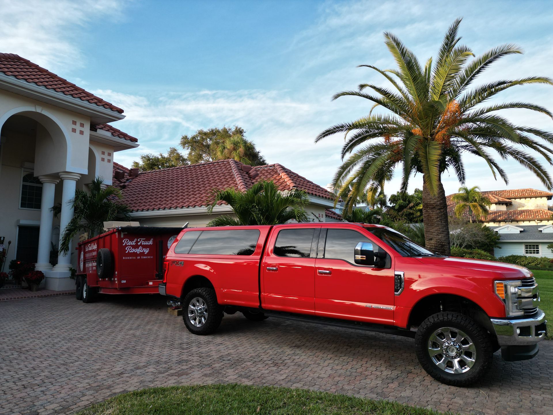 Roofer in Tampa FL handing a homeowner a tablet with roof inspection photos during a free Red Truck Roofing roof inspection