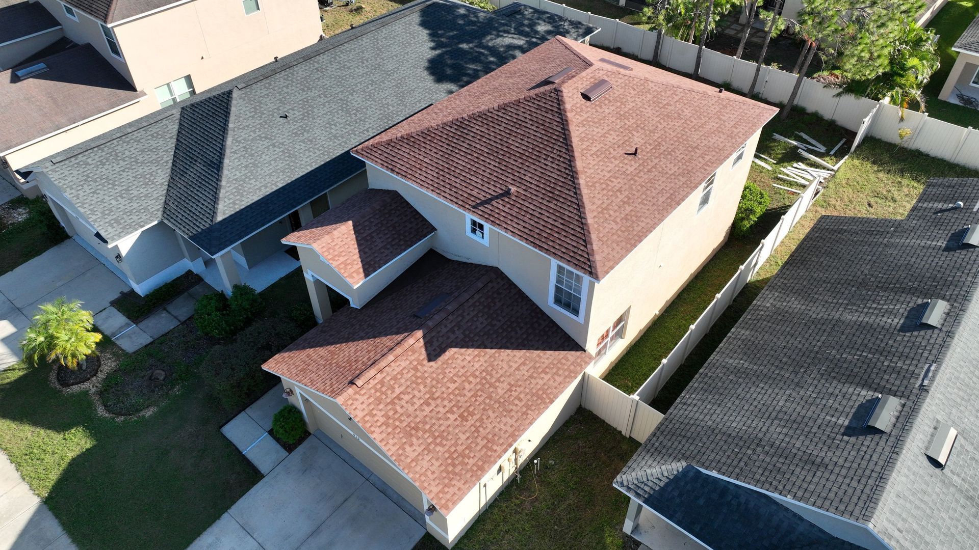 Wind damage roof repair near you: Red Truck Roofing inspector marking creased and lifted shingles with chalk for an insurance claim photo report