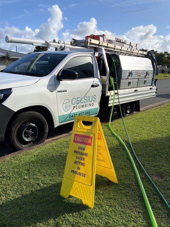 A plumber clearing a blocked drain on the Sunshine Coast