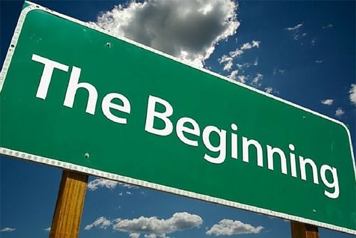 a green sign that says the beginning on it