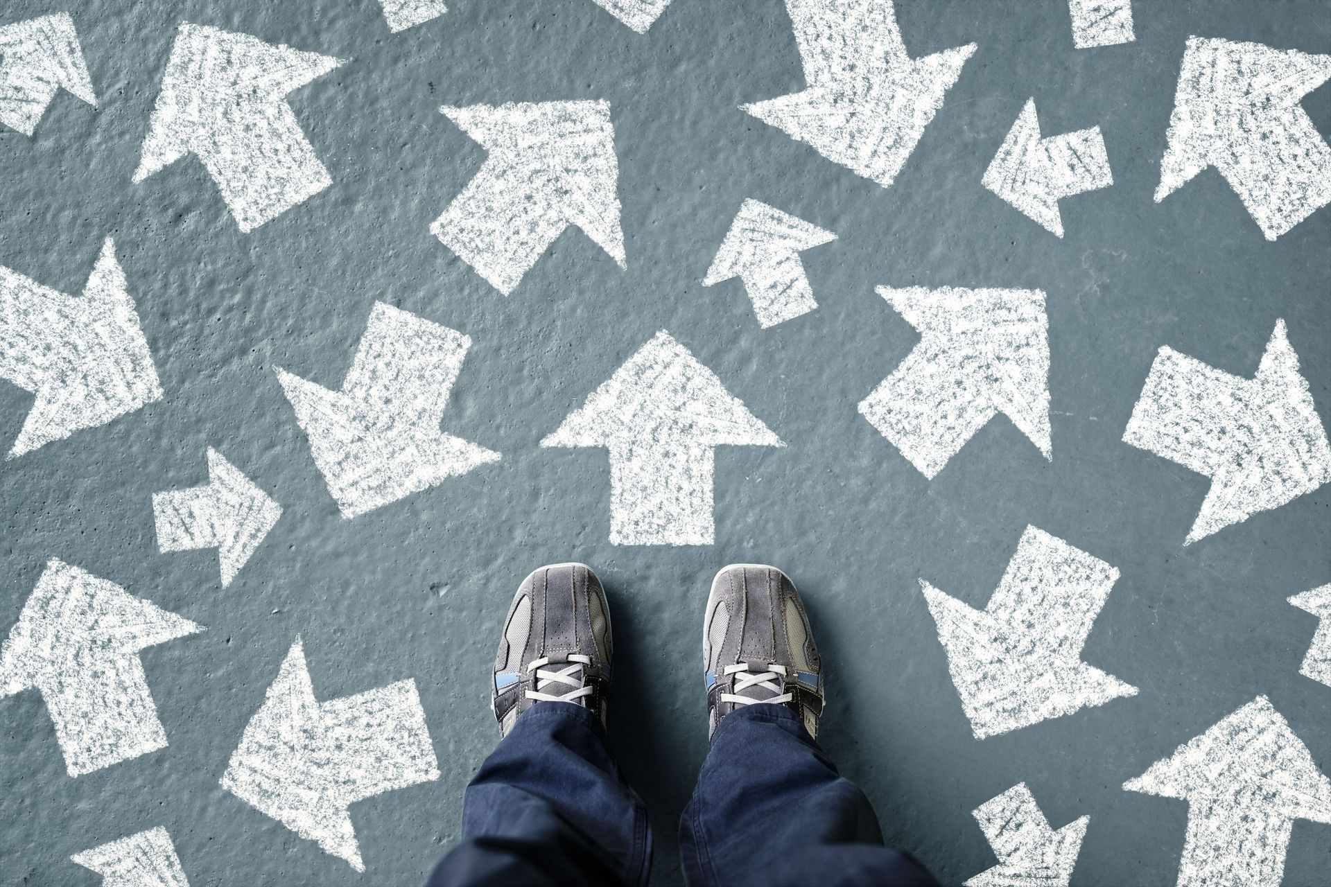 a person standing on a concrete floor with arrows pointing in different directions